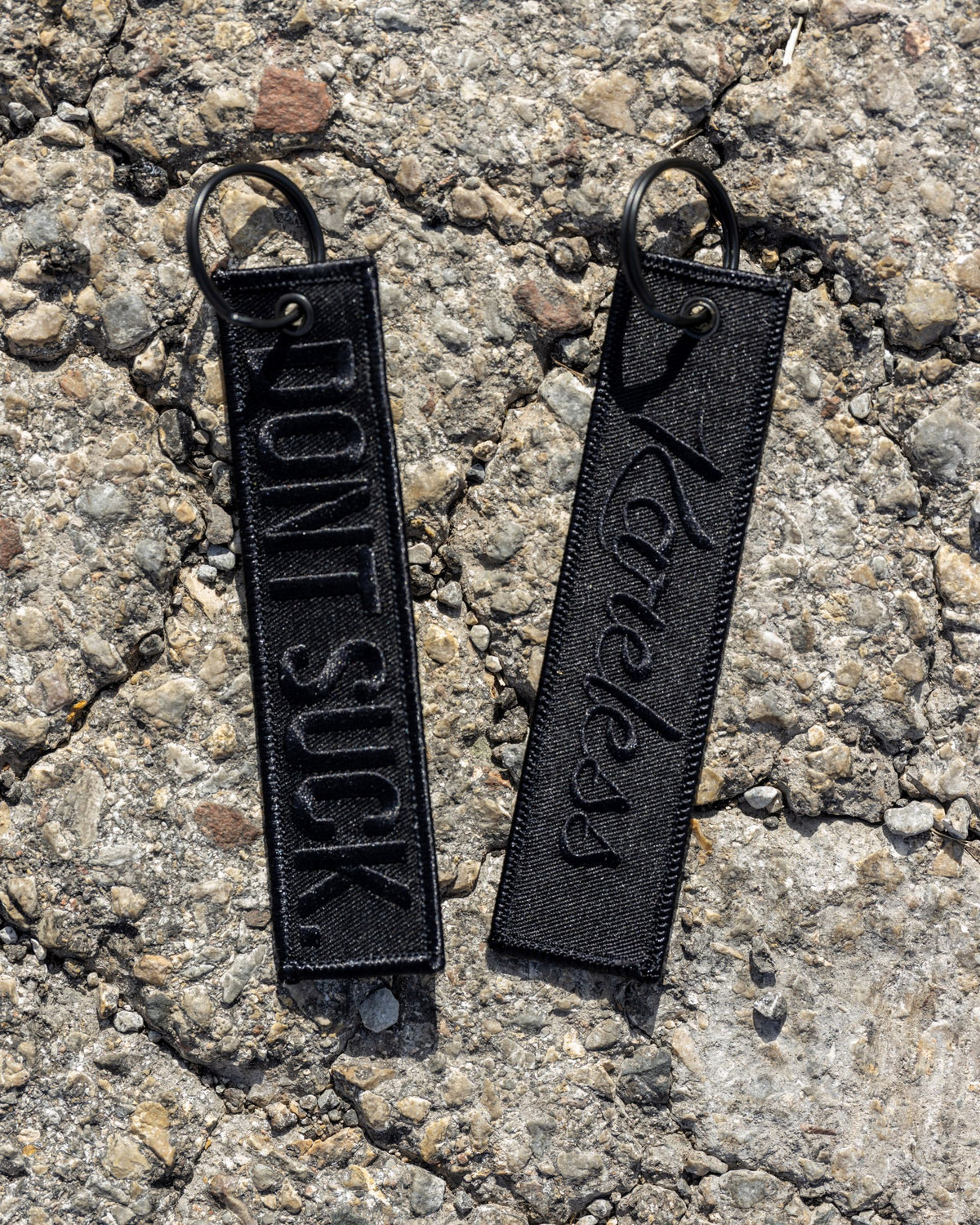'DONT SUCK.' Black-on-Black Key Tag