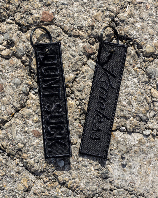 'DONT SUCK.' Black-on-Black Key Tag